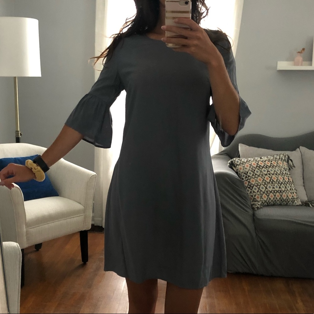 Grey dress with ruffle sleeves.